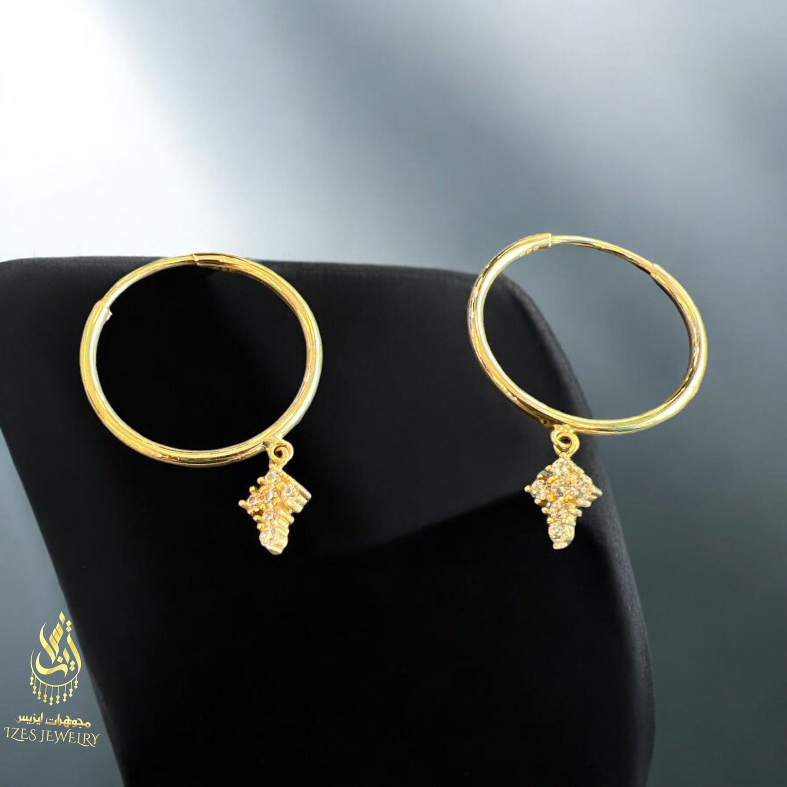 women earrings feature simple and elegant gold hoops from which a small cross-shaped - Image 7