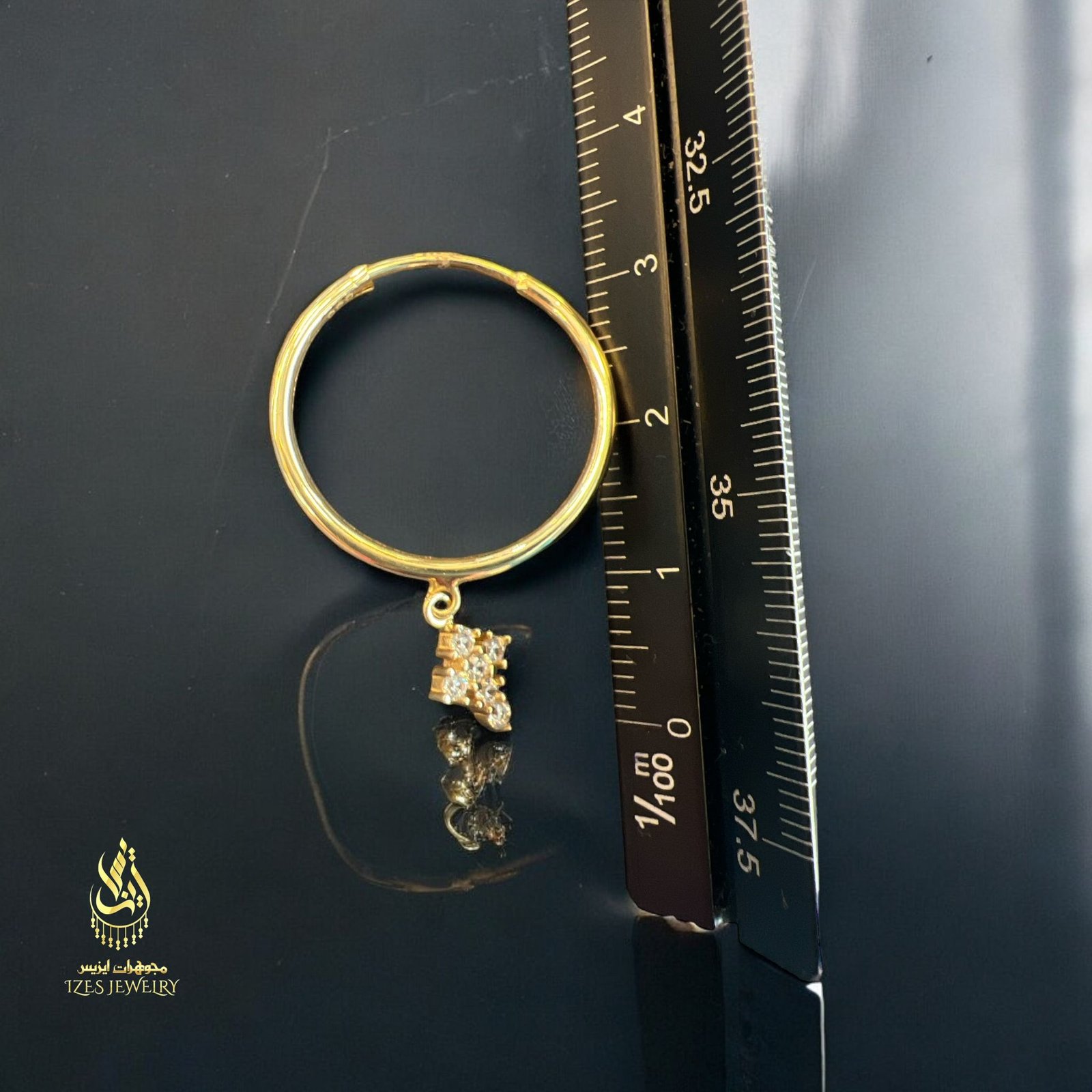 women earrings feature simple and elegant gold hoops from which a small cross-shaped - Image 2