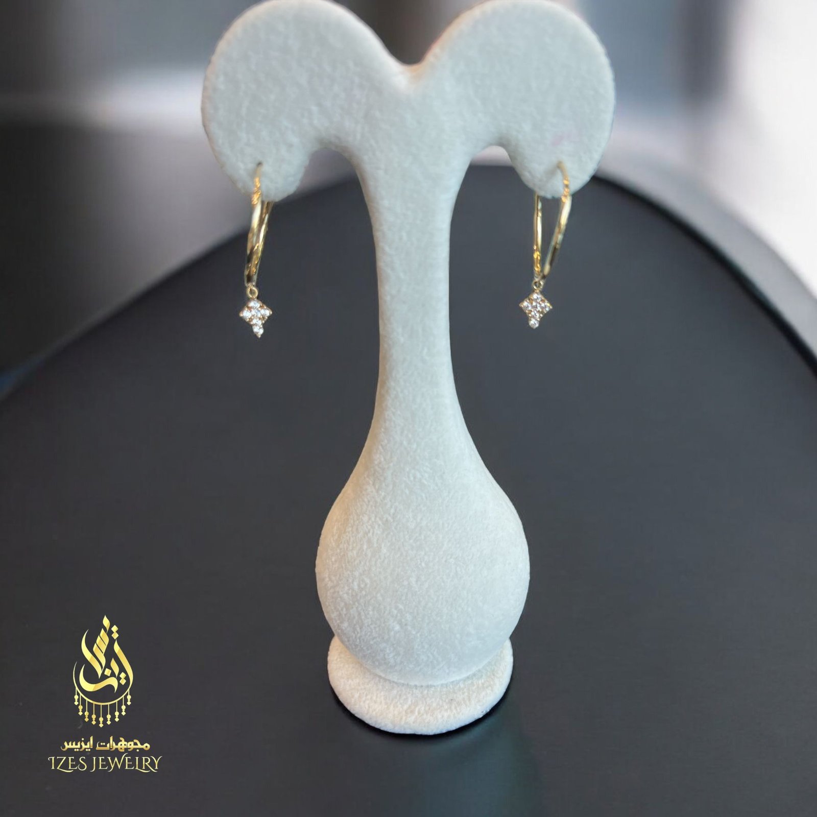 women earrings feature simple and elegant gold hoops from which a small cross-shaped