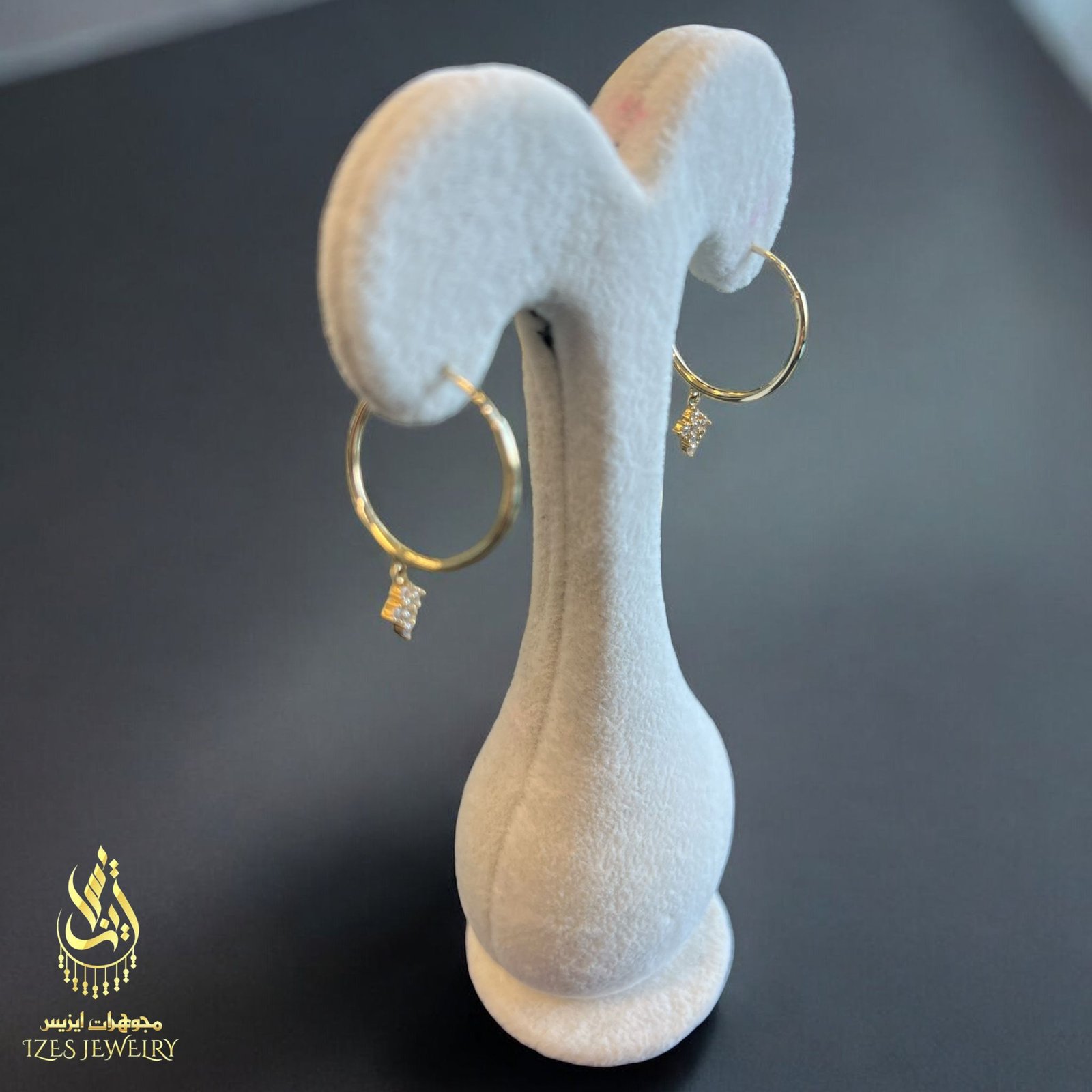 women earrings feature simple and elegant gold hoops from which a small cross-shaped - Image 4