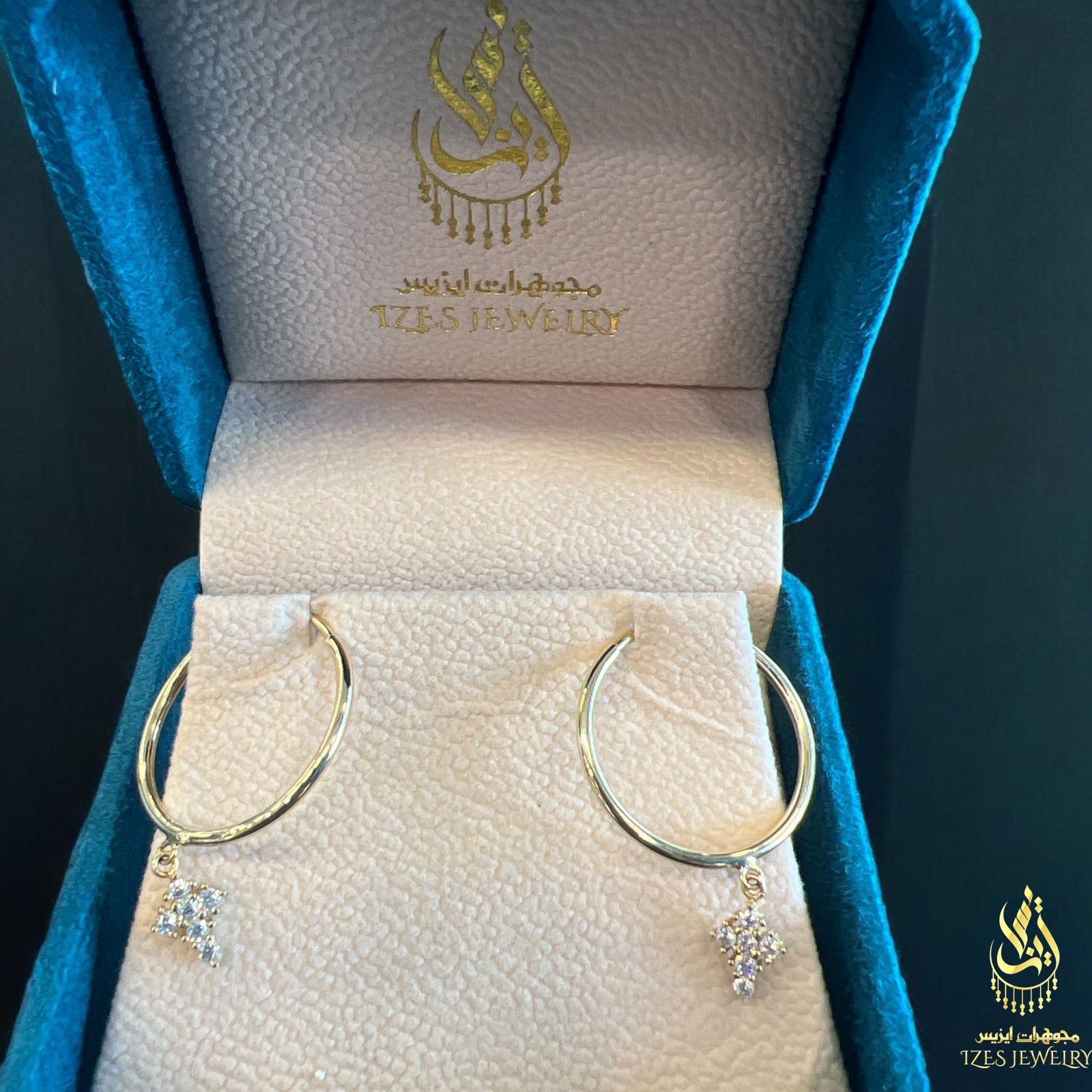 women earrings feature simple and elegant gold hoops from which a small cross-shaped - Image 5