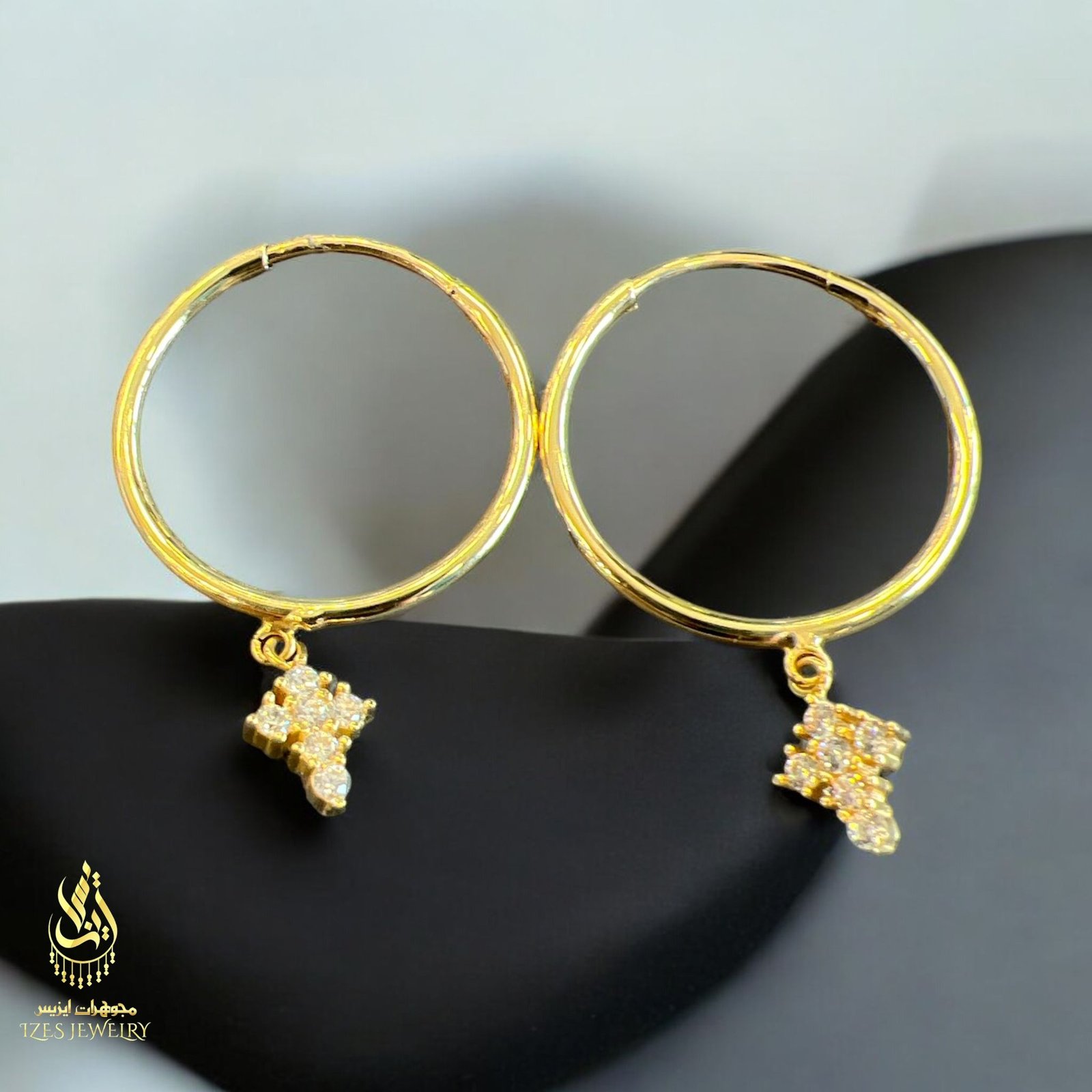 women earrings feature simple and elegant gold hoops from which a small cross-shaped - Image 6