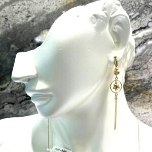 New long 14K yellow gold earrings feature a delicate star gracefully placed